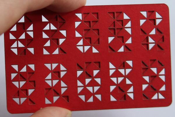 Two visual cryptography cards in red revealing the characters "5", "9", and "L"